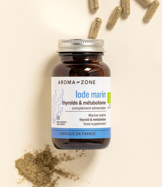 Complément alimentaire Iode Marin Aroma-Zone sur fond beige avec des gélules et de la poudre