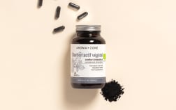 Complément alimentaire Charbon actif Aroma-Zone sur fond beige avec des gélules et de la poudre